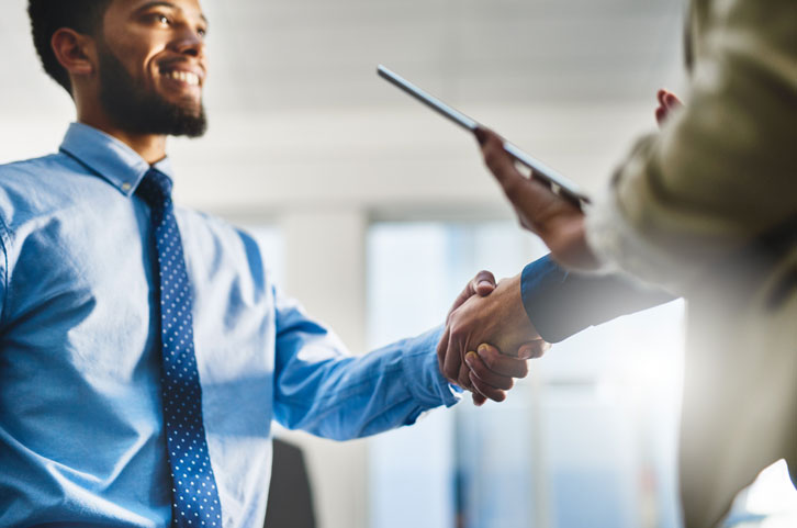 Colleagues shaking hands with eachother