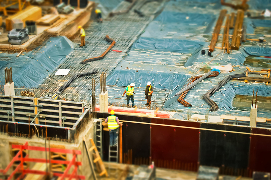 Construction workers working on a ceiling of a building