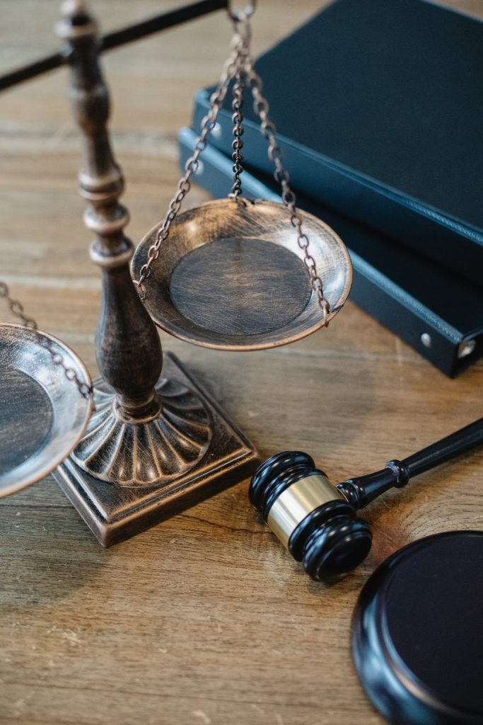 Weight scales on a wooden desk next to a gabble