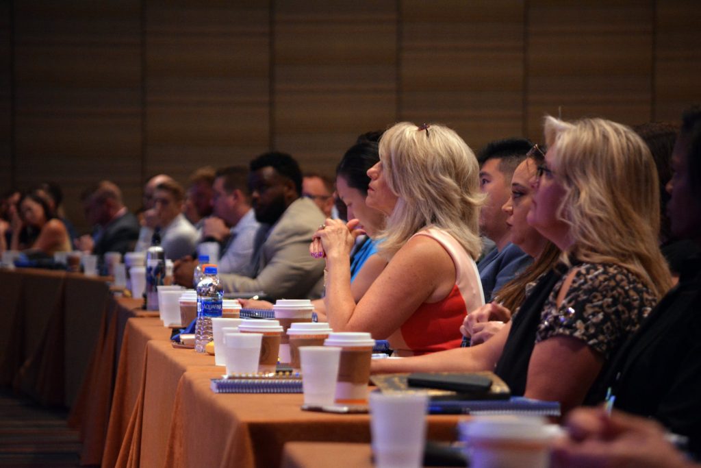 People listening to a presentation with their coffees