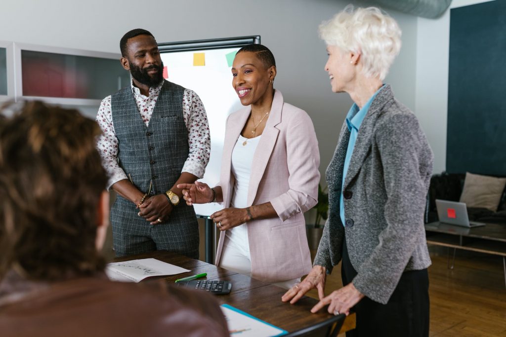 Three colleagues giving a presentation in a meeting