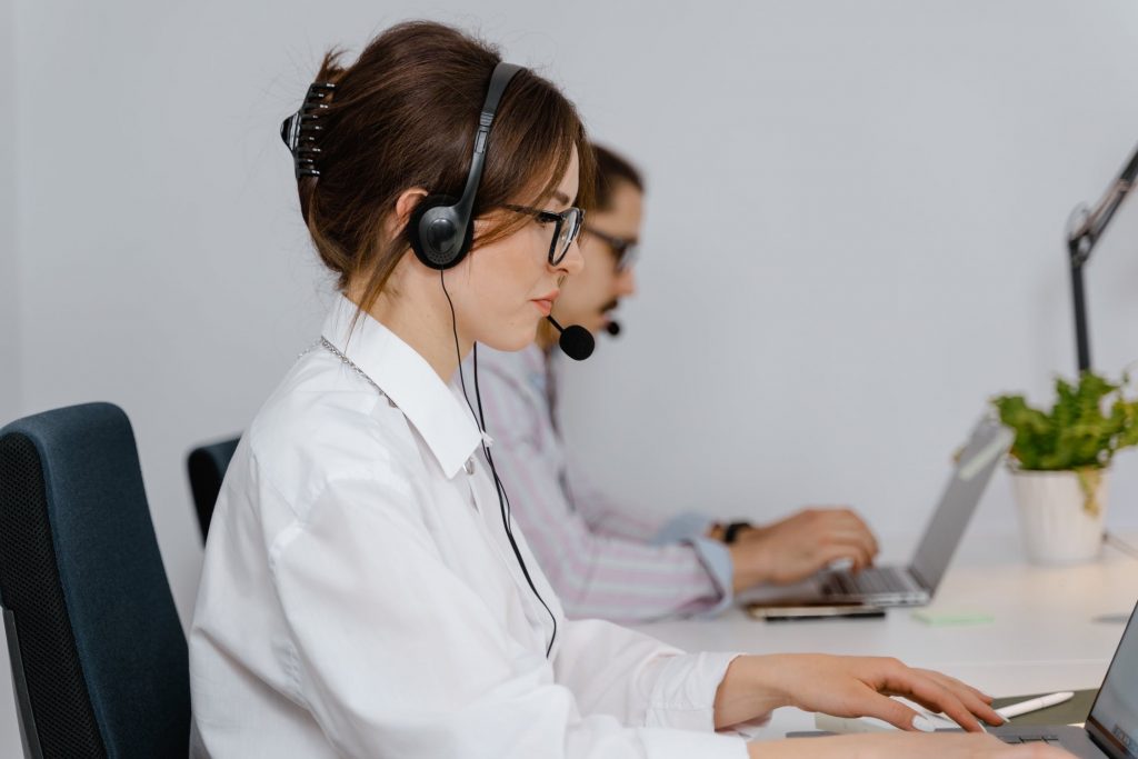 Man and woman at a call center with their laptops