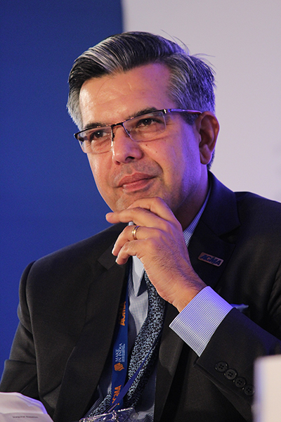 Man in a suit thinking in front of a blue and white background