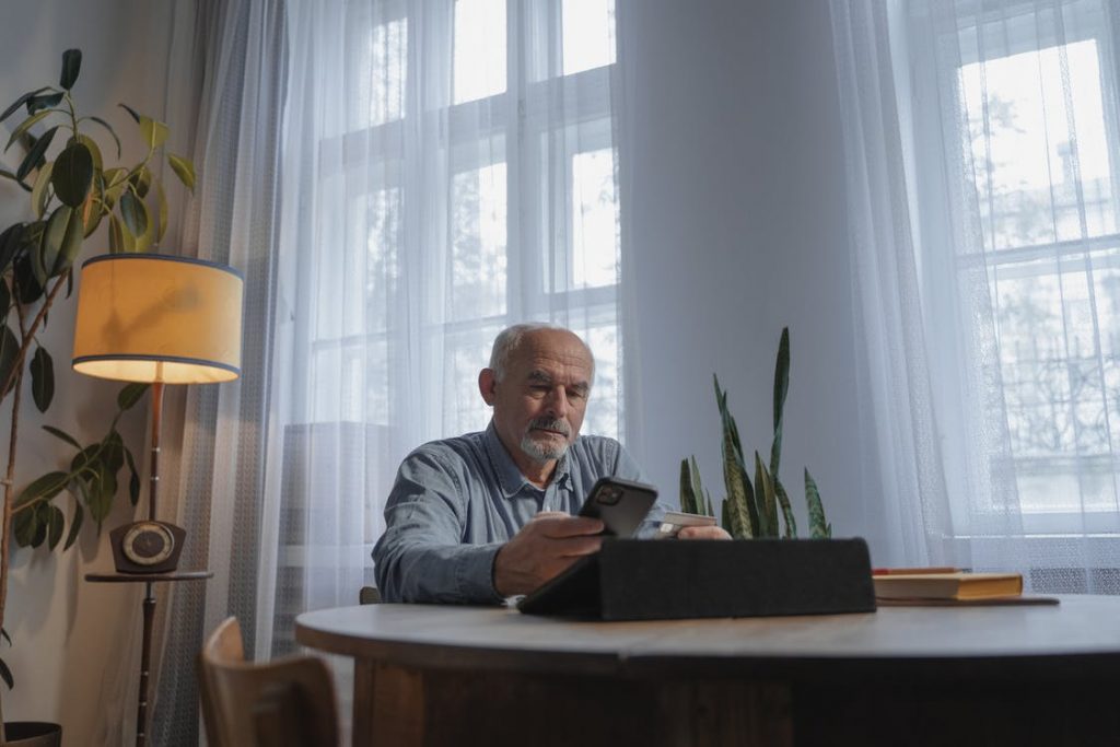 Man at a desk using his phone