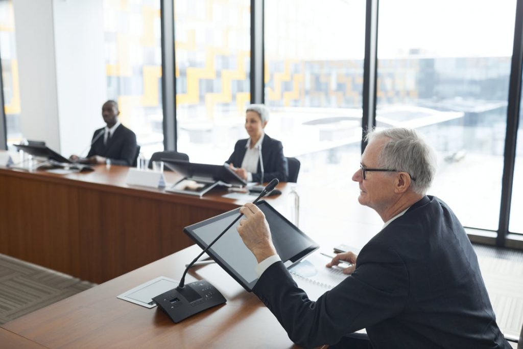 Three trustees sitting around a table in an office setting