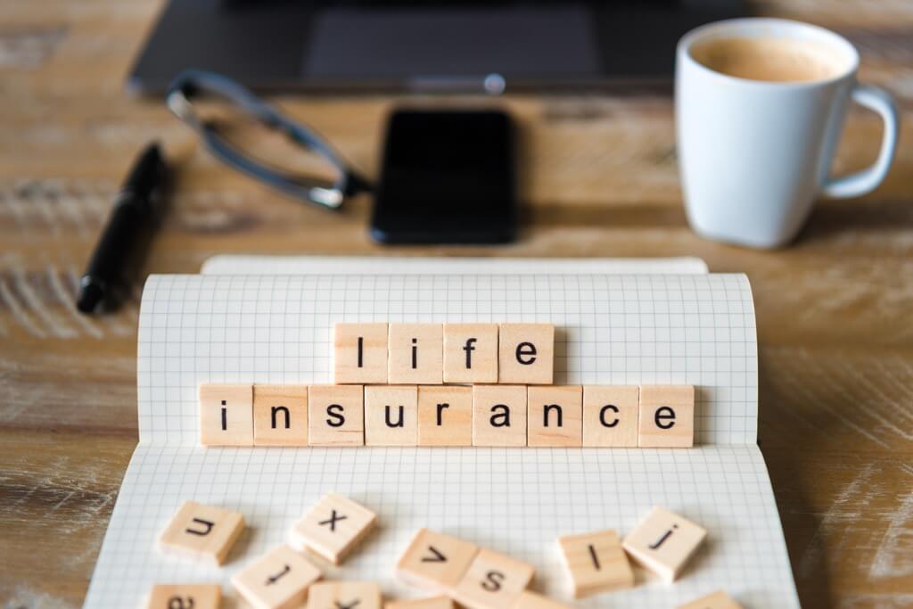 Life insurance written on square blocks on a piece of paper