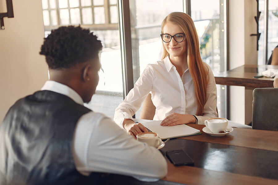 Man and woman having a meeting with a notebook