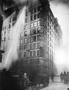 Old photo of firefighters fighting a fire at the Triangle Shirtwaist Factory