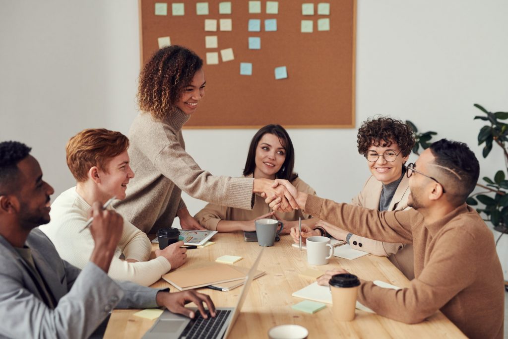 People making a deal at a meeting in an office setting