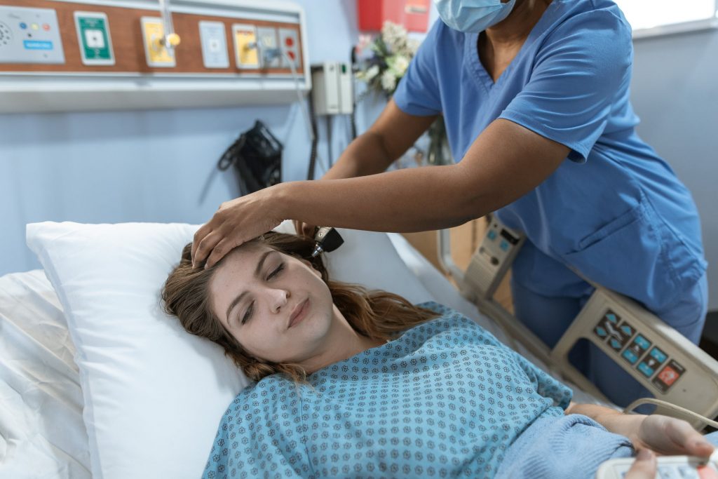 Doctor checking the ears of a patient