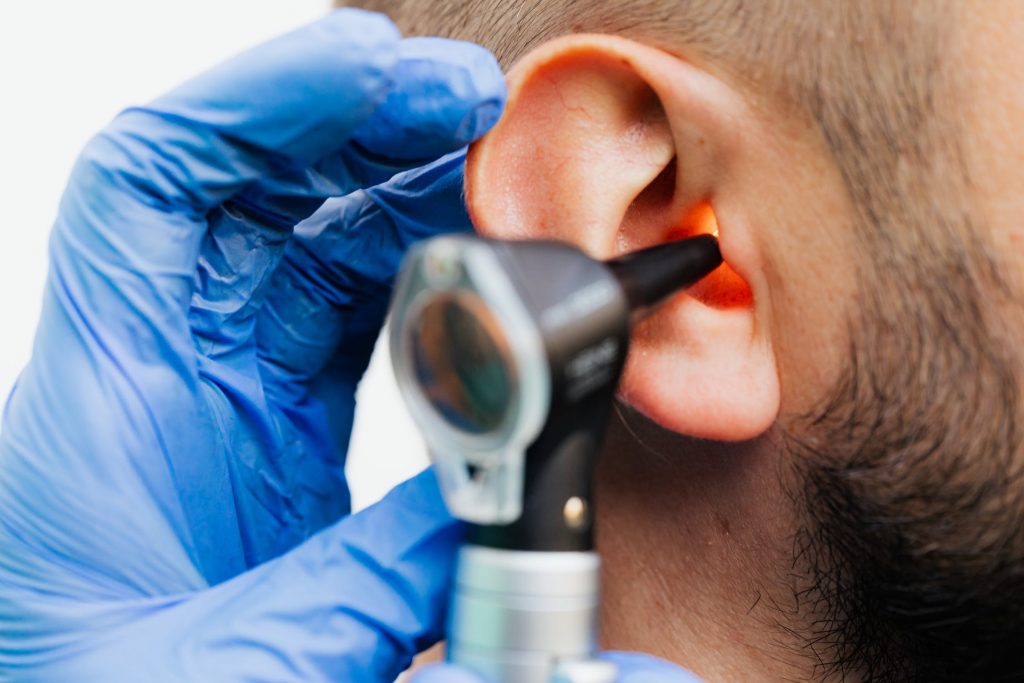 Doctor checking the ears of a patient