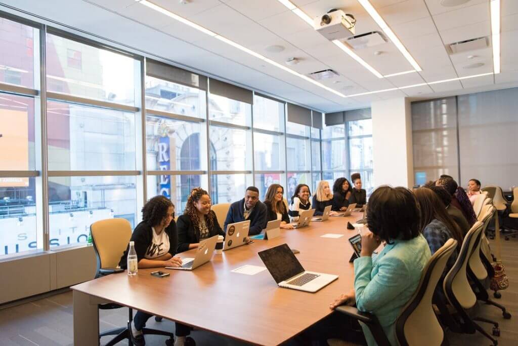 Colleagues at having an office meeting with laptops