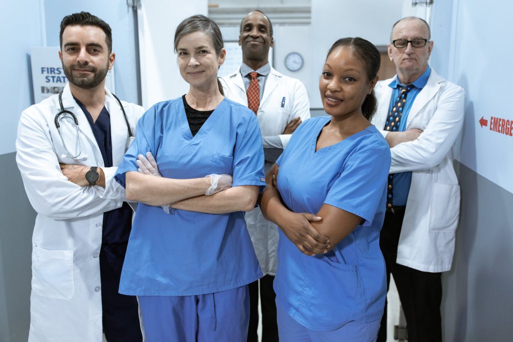 Doctors in a hospital hallway with their arms crossed