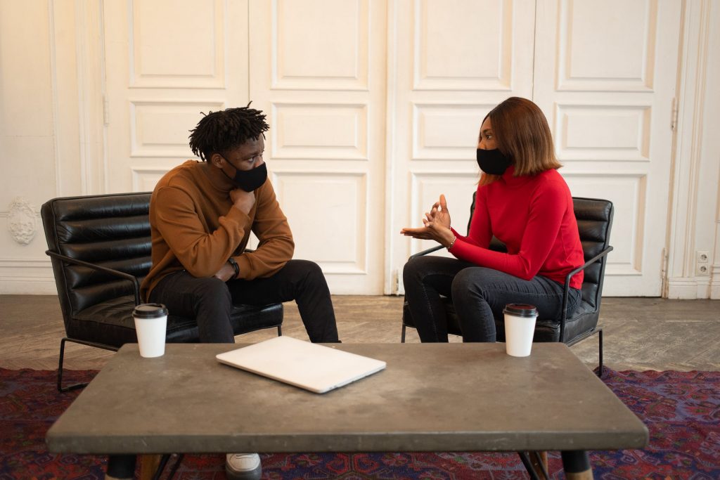 Two people having a meeting with coffee and a laptop